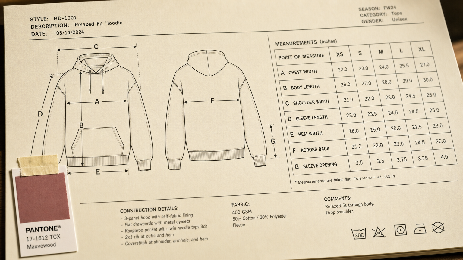 A tech pack measurement page with A–G callouts beside a graded size chart table across XS to XL